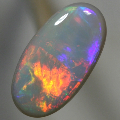 SOLID SEMI BLACK OPAL Rolling flashes of red and neon orange to magenta and purple